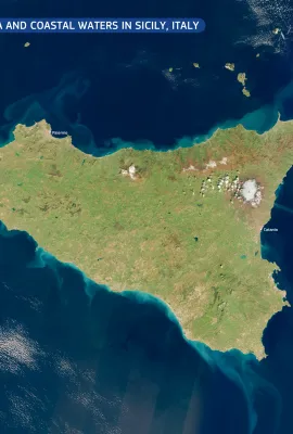 Snow-capped Mount Etna and coastal waters in Sicily, Italy