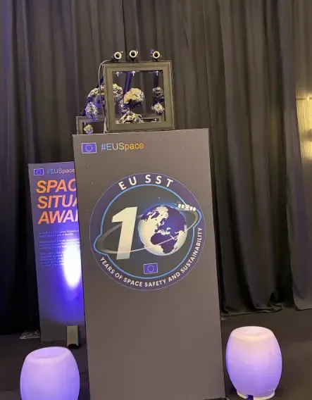 A picture of a podium during the EU Space Days 2026 event in Cyprus displaying the EU SST 10 Years of Space Safety and Sustainability anniversary logo.