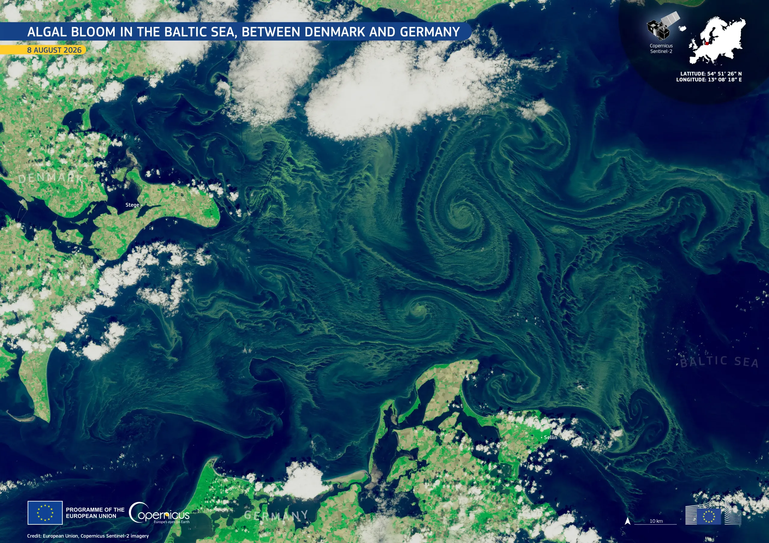 Satellite image of the Baltic Sea between Denmark and Germany on 8 August 2026, showing extensive green algal blooms swirling in large spiral patterns across the dark blue water. Clouds partially cover the surrounding coastlines, with Denmark visible to the northwest and Germany to the south.