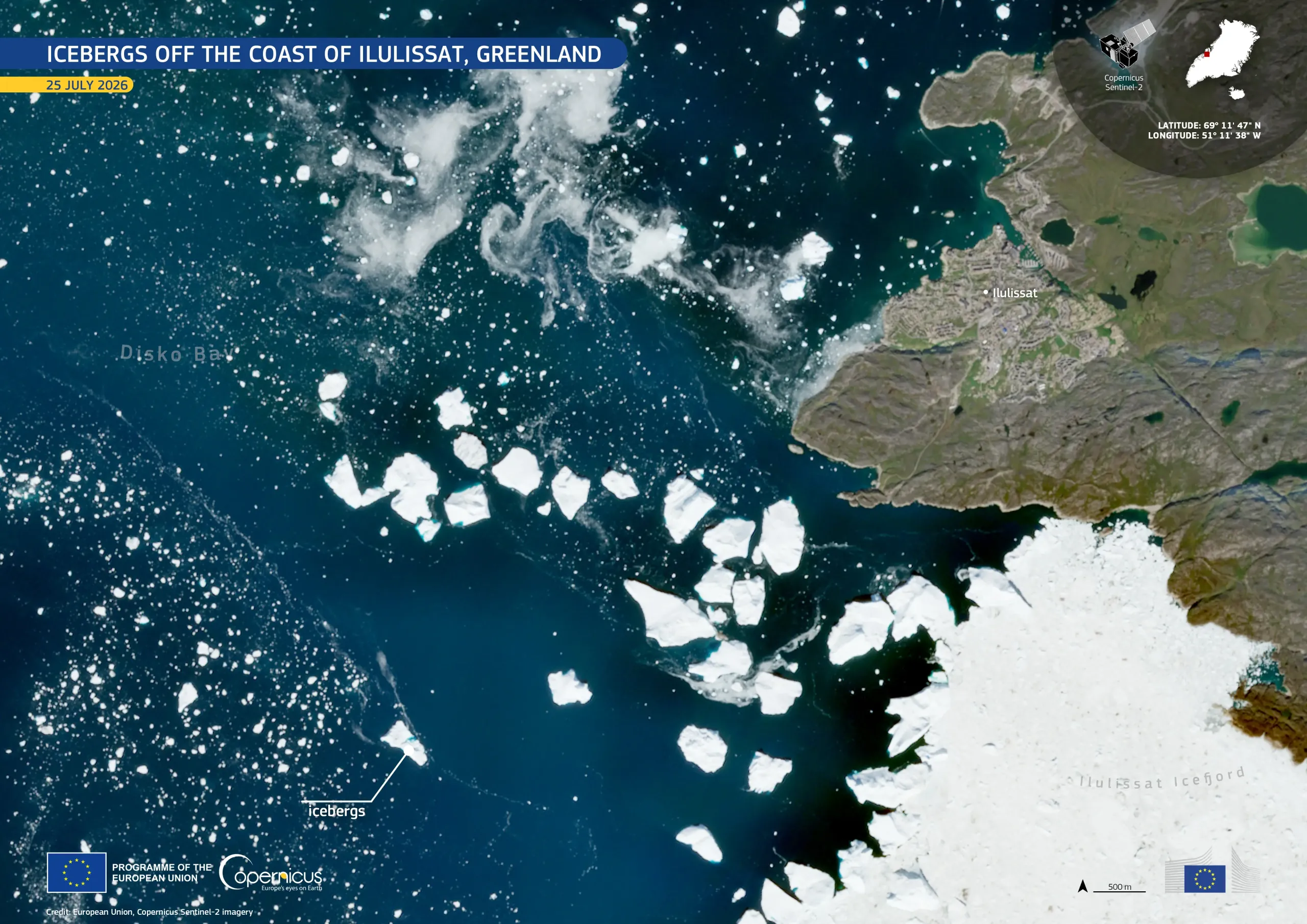 Satellite image of the coast near Ilulissat, Greenland, on 25 July 2026. Dark blue waters of Disko Bay are scattered with dozens of bright white icebergs of varying sizes drifting away from the mouth of Ilulissat Icefjord, which is covered by a large expanse of sea ice at the lower right. The town of Ilulissat appears along the rocky coastline on the right, with labels identifying the bay, icefjord, and icebergs. An inset map marks the location in Greenland, and Copernicus Sentinel-2 branding, coordinates, 