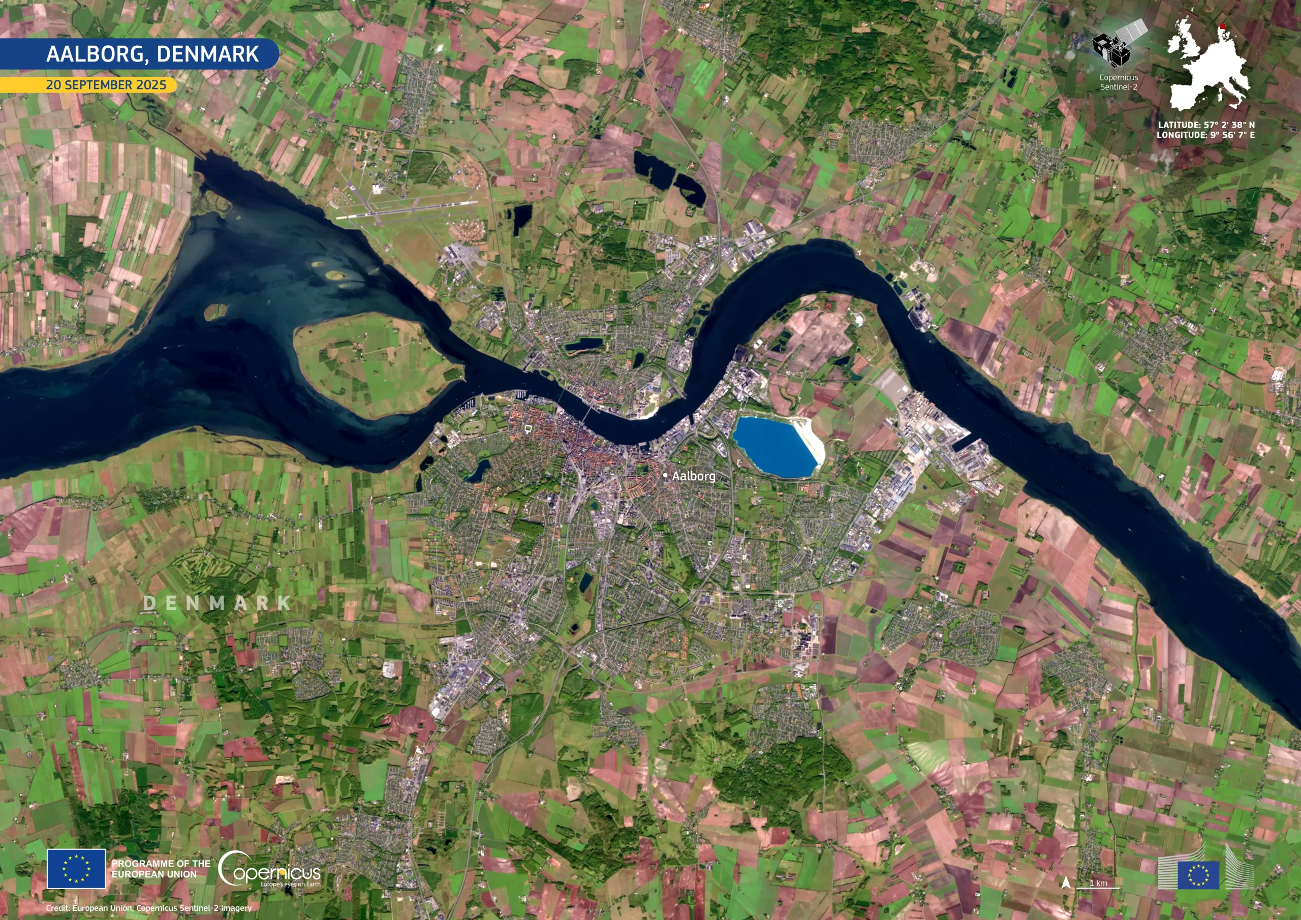 Satellite image of Aalborg, Denmark, showing the city divided by a river with surrounding green farmland and rural areas.