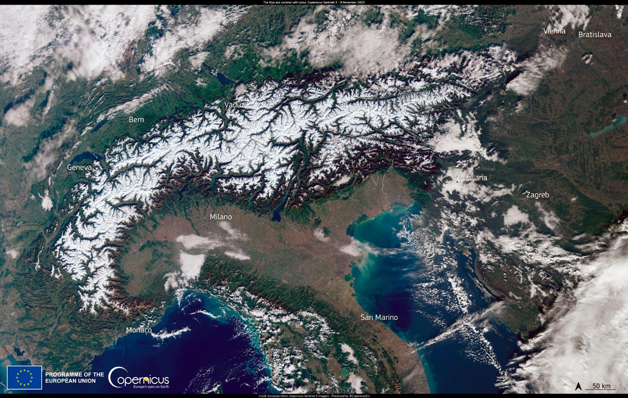 Satellite image from Copernicus Sentinel-3 showing the snow-covered Alps and surrounding cities including Geneva, Milano, and Vienna on 8 November 2023.