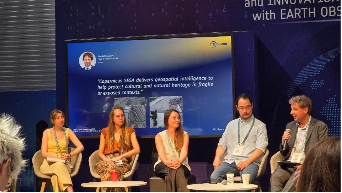 A panel discussion featuring various speakers, with a presentation on geospatial intelligence and its role in preserving heritage.