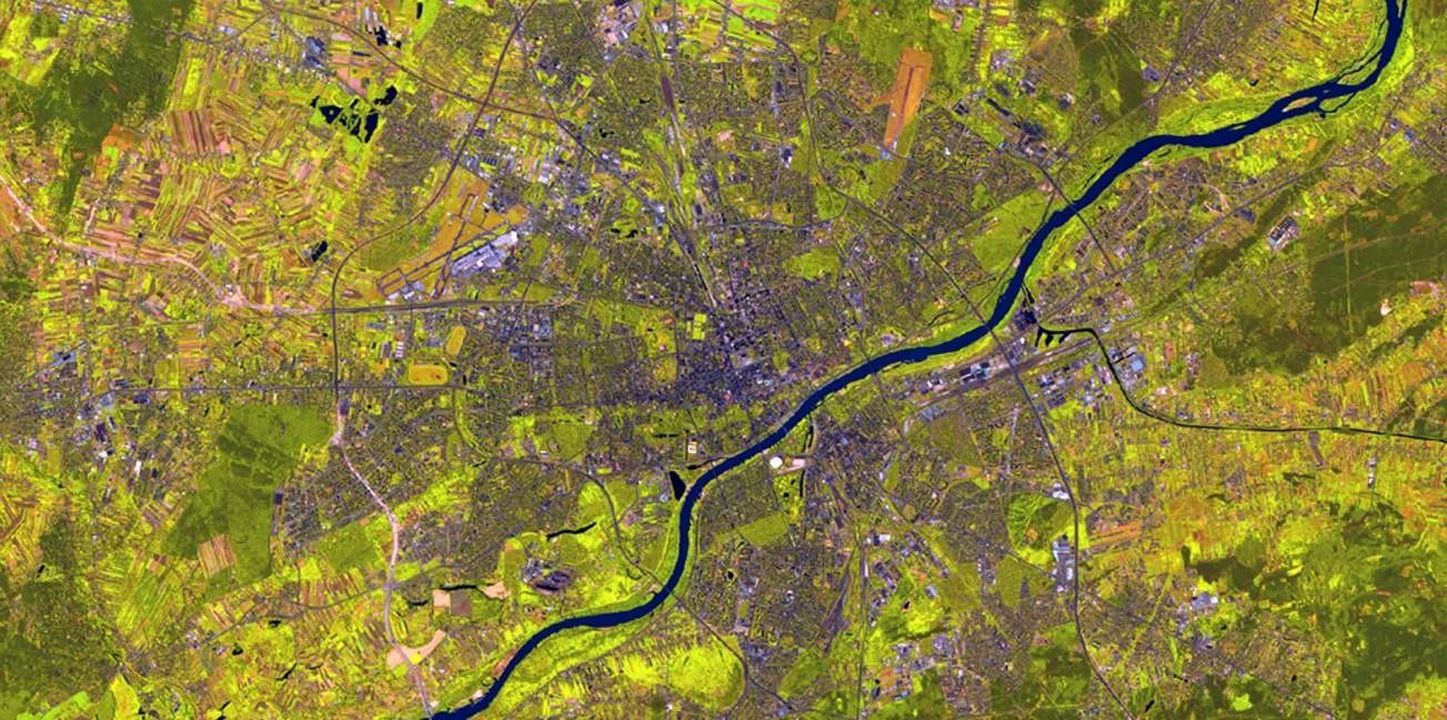 False-colour Copernicus Sentinel-2 image of Warsaw, with built-up areas in shades of purple, and vegetation in bright green. Credit: European Union, Sentinel-2 imagery.