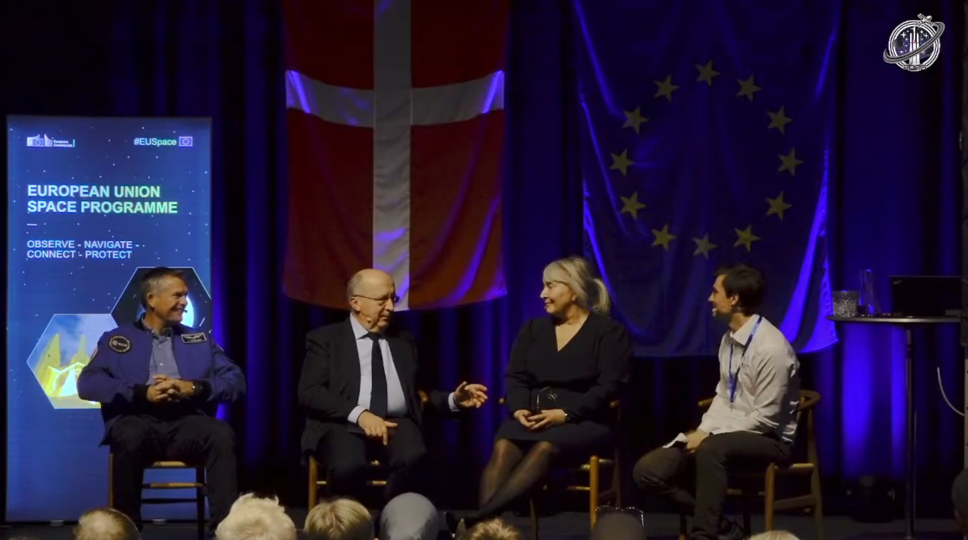A group of people sitting on chairs.