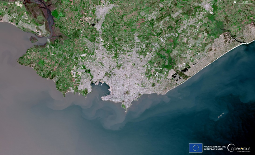 This image shows an aerial view of Montevideo, the capital city of Uruguay, as captured by a Copernicus Sentinel satellite. The city is prominently situated along the coastline, bordered by the Rio de la Plata estuary on the left and the South Atlantic...