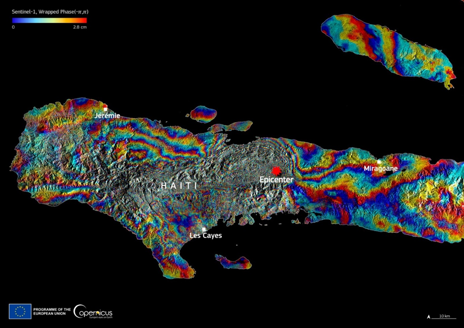 Sentinel-1 interferogram showing ground deformation in Haiti caused by the 14 August 2021 earthquake. Coloured fringes indicate varying levels of displacement, with the epicentre marked and nearby cities labelled.