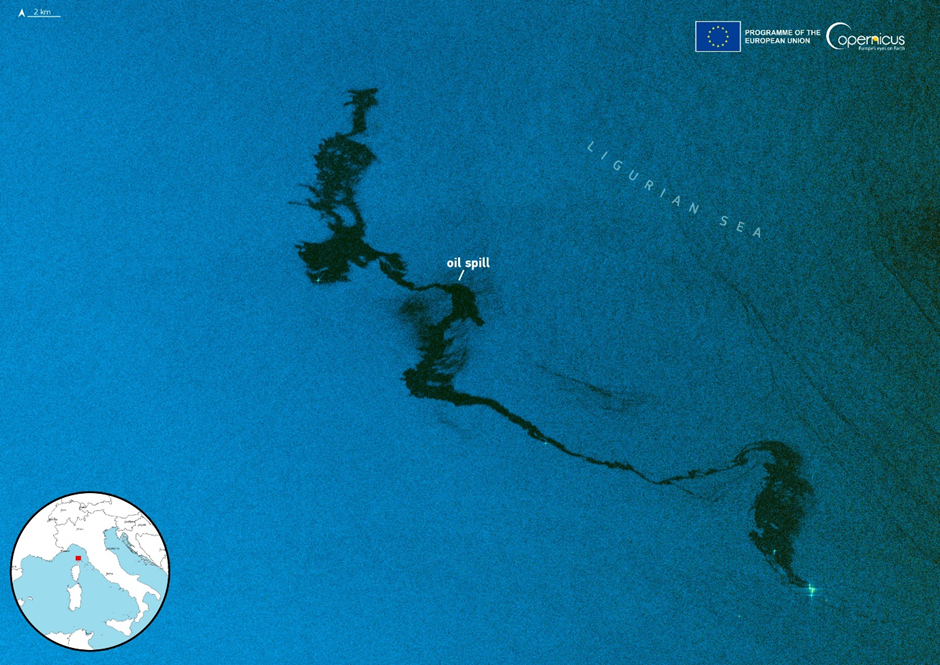 Sentinel-1 radar image of an oil spill in the Ligurian Sea, north of Corsica, caused by a vessel collision. The spill appears as dark streaks on the ocean surface, with a map inset showing the location.