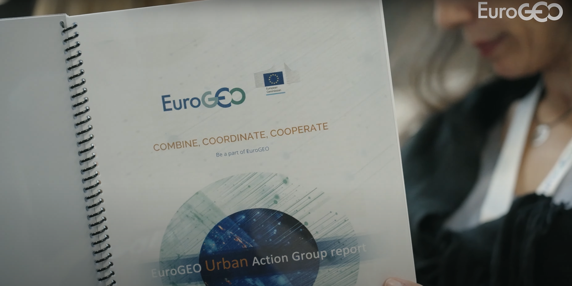 A person holding a white paperDescription automatically generated