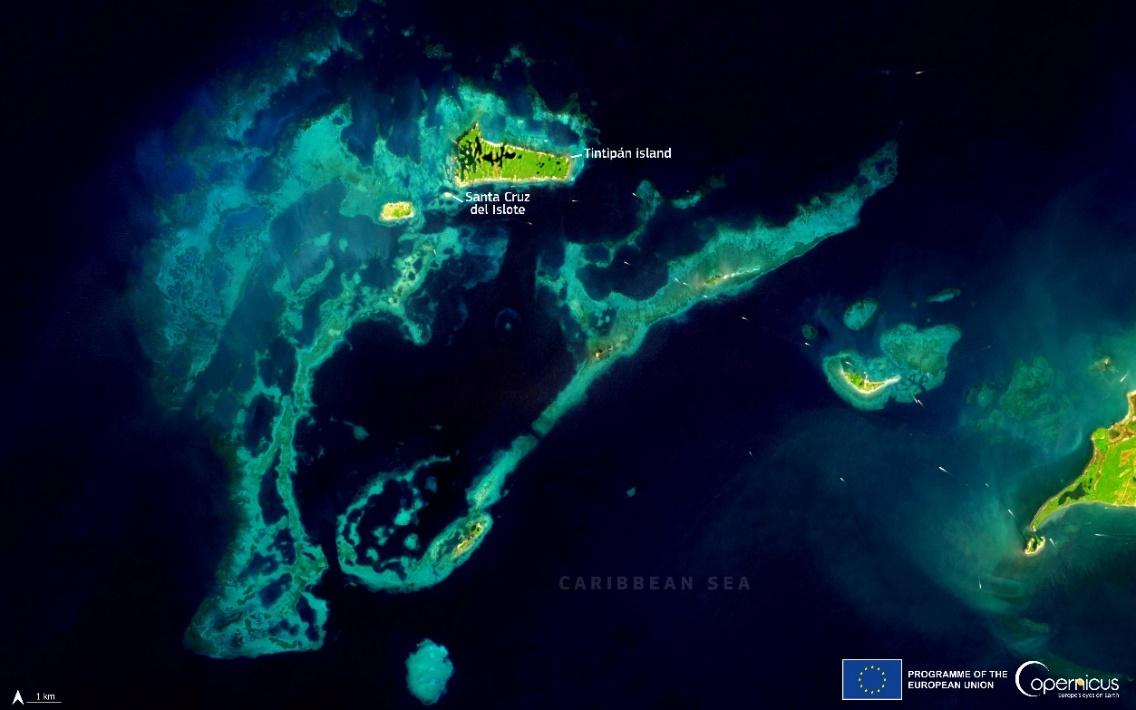 An aerial view of islands and waterDescription automatically generated