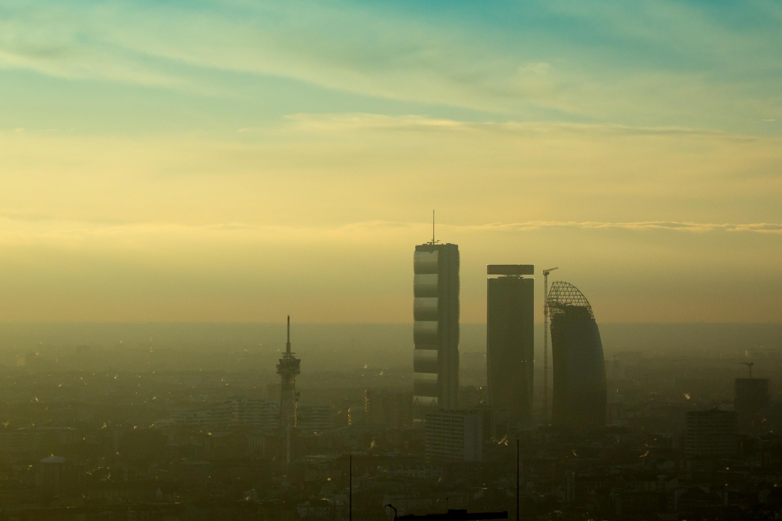 Smog lingers over Milan as pollutants from traffic and industry accumulate in the Po Valley. Temperature inversions, common in winter, trap pollution close to the ground, worsening air quality.